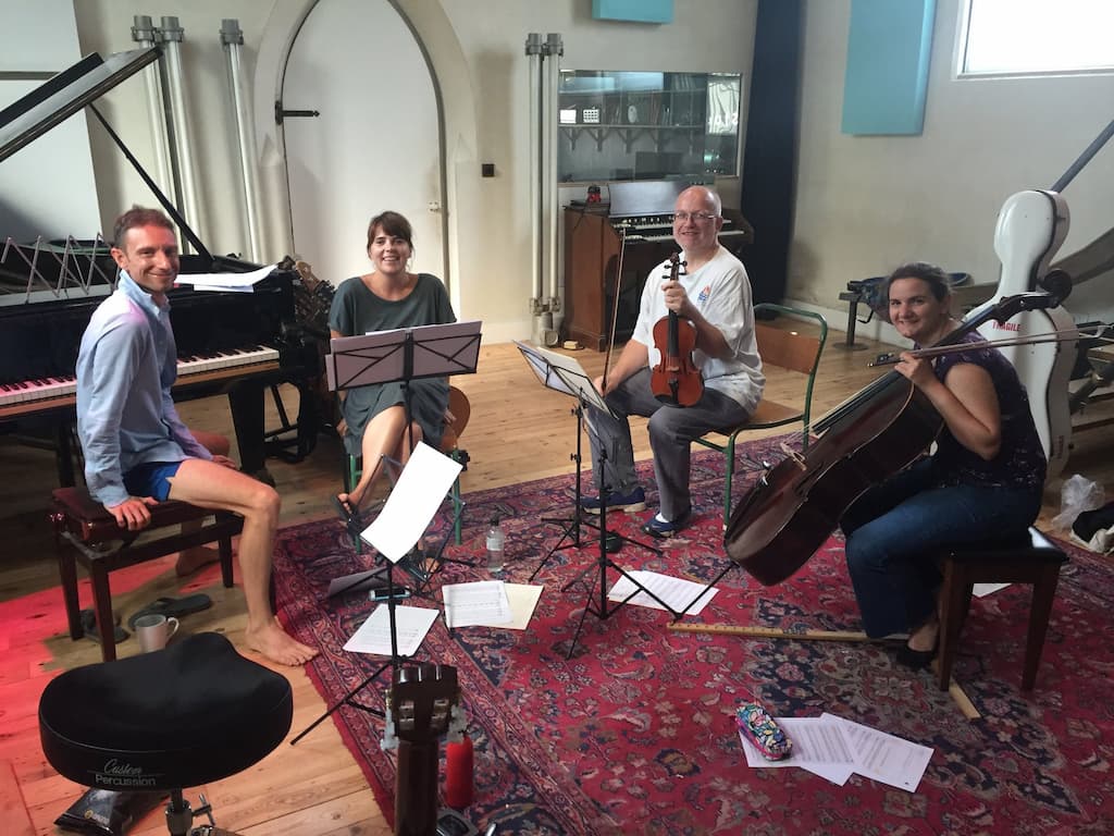 Four musicians in a studio