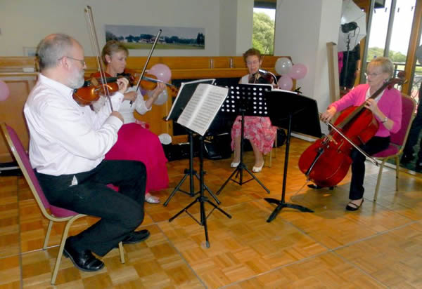 String quartet wearing pink