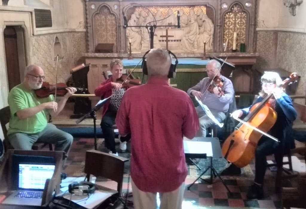String quartet with conductor in a recording session